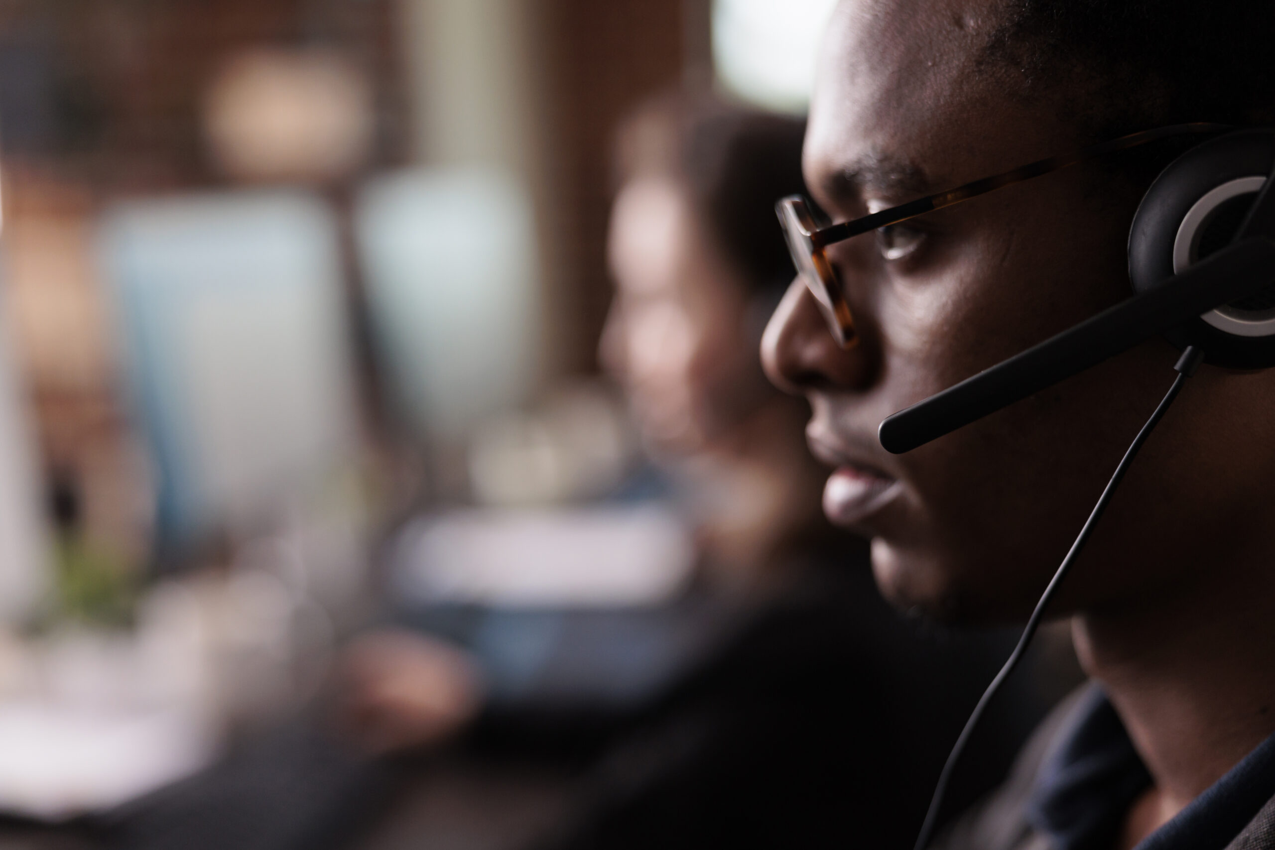 Shot of a young man and woman using a computer while working in a call centre
